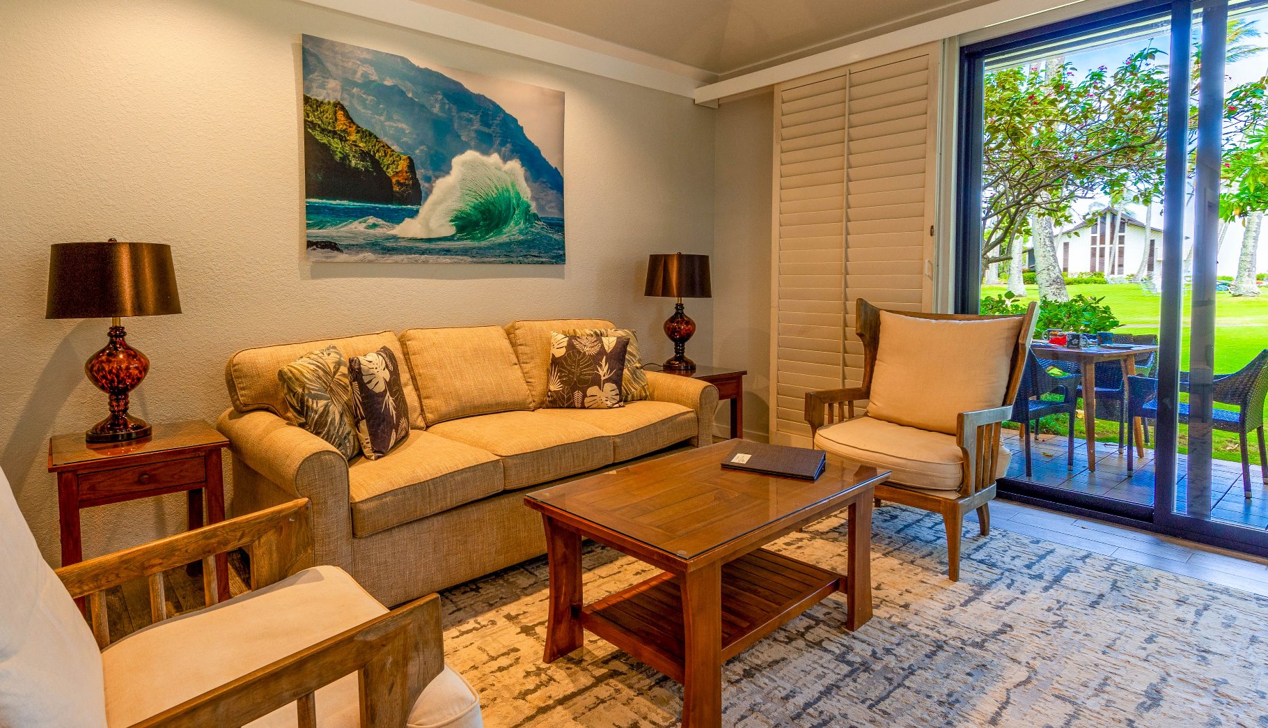 2253 Poipu Road, Unit 183 Koloa, HI 96756 - Photo 23 of 30 a blue couch sitting in a living room next to a window