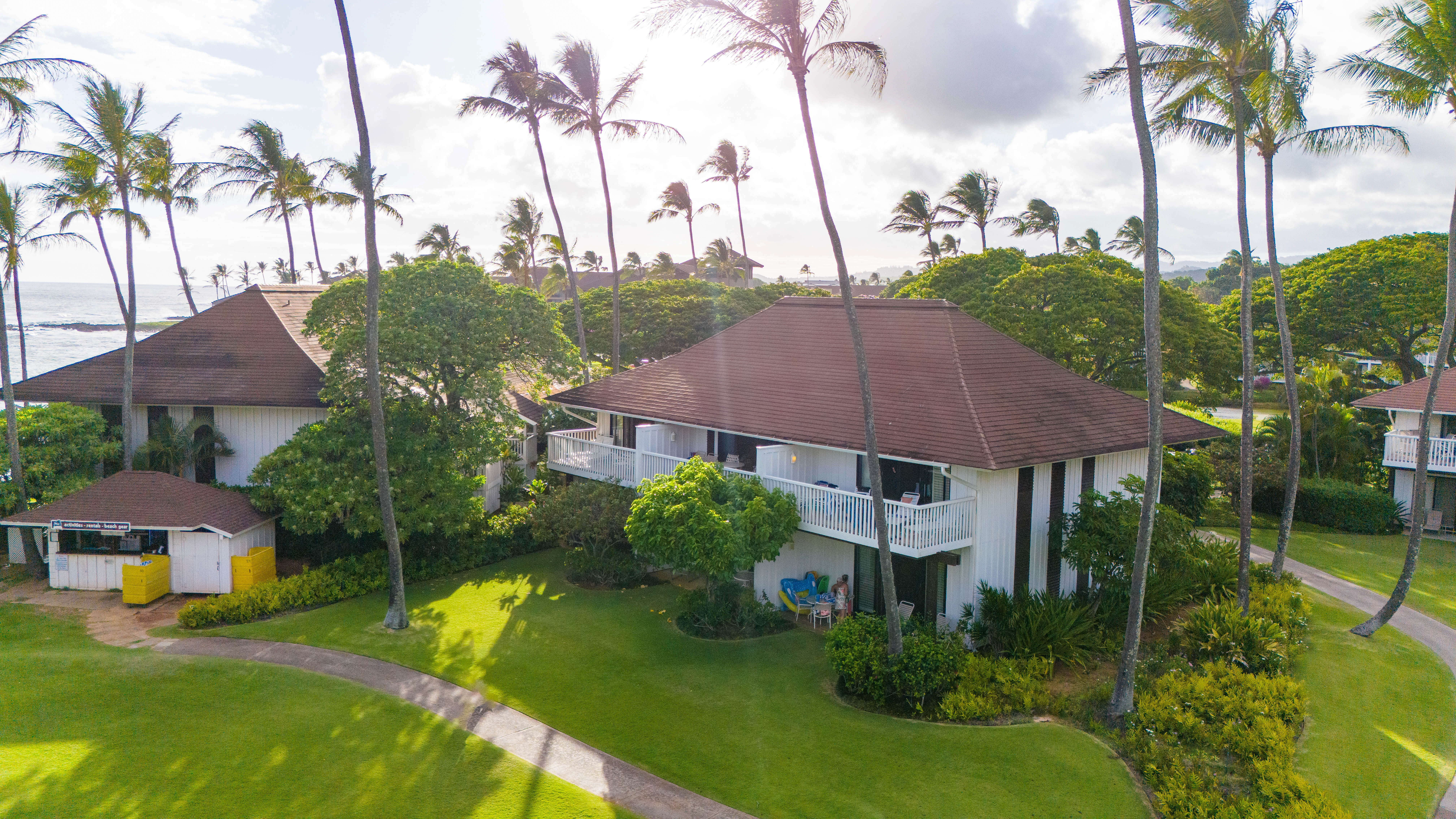 2253 Poipu Road, Unit 183 Koloa, HI 96756 - Photo 29 of 30 a aerial view of a house with a yard and palm trees