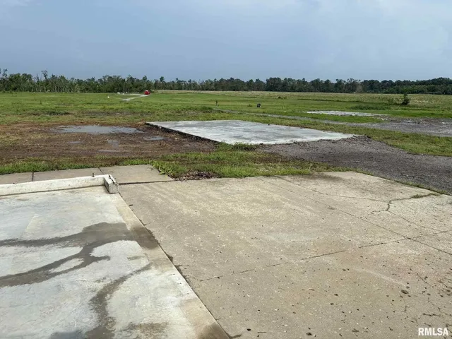 a view of a field with an ocean view