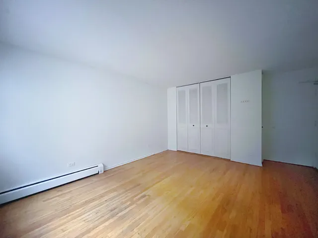 a view of an empty room and wooden floor
