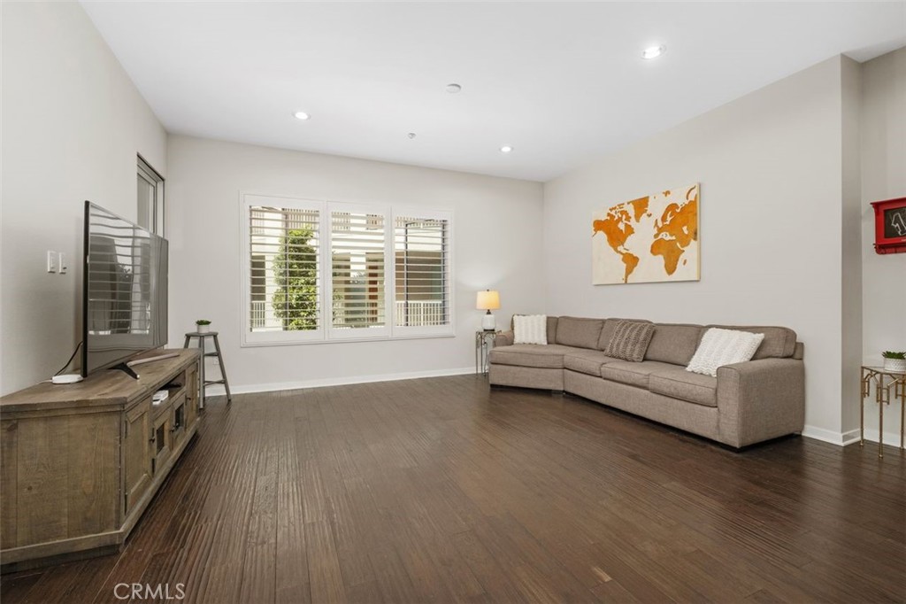 21 Gramercy, Unit 202 Irvine, CA 92612 - Photo 13 of 37 a living room with furniture and a flat screen tv