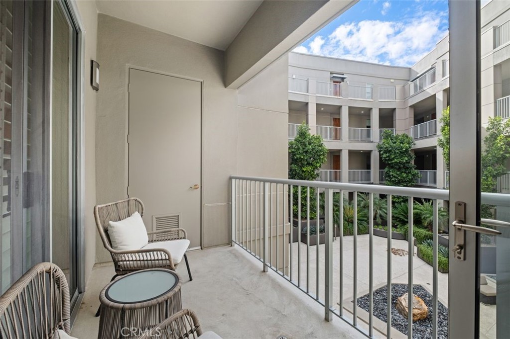 21 Gramercy, Unit 202 Irvine, CA 92612 - Photo 9 of 37 a balcony with a couch and chairs