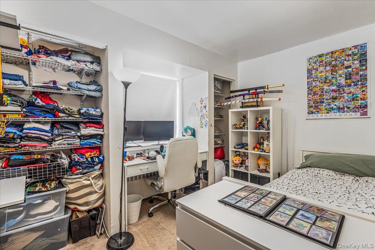 144-55 Melbourne Avenue, Unit 6E Queens, NY 11367 - Photo 12 of 24 Bedroom with a desk and light colored carpet