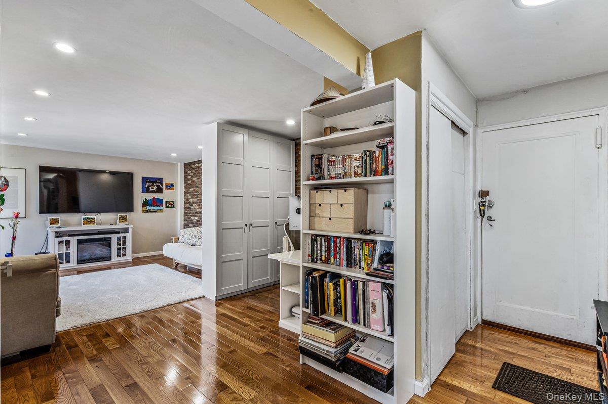 144-55 Melbourne Avenue, Unit 6E Queens, NY 11367 - Photo 7 of 24 Living area with dark wood-style flooring, a glass covered fireplace, and recessed lighting