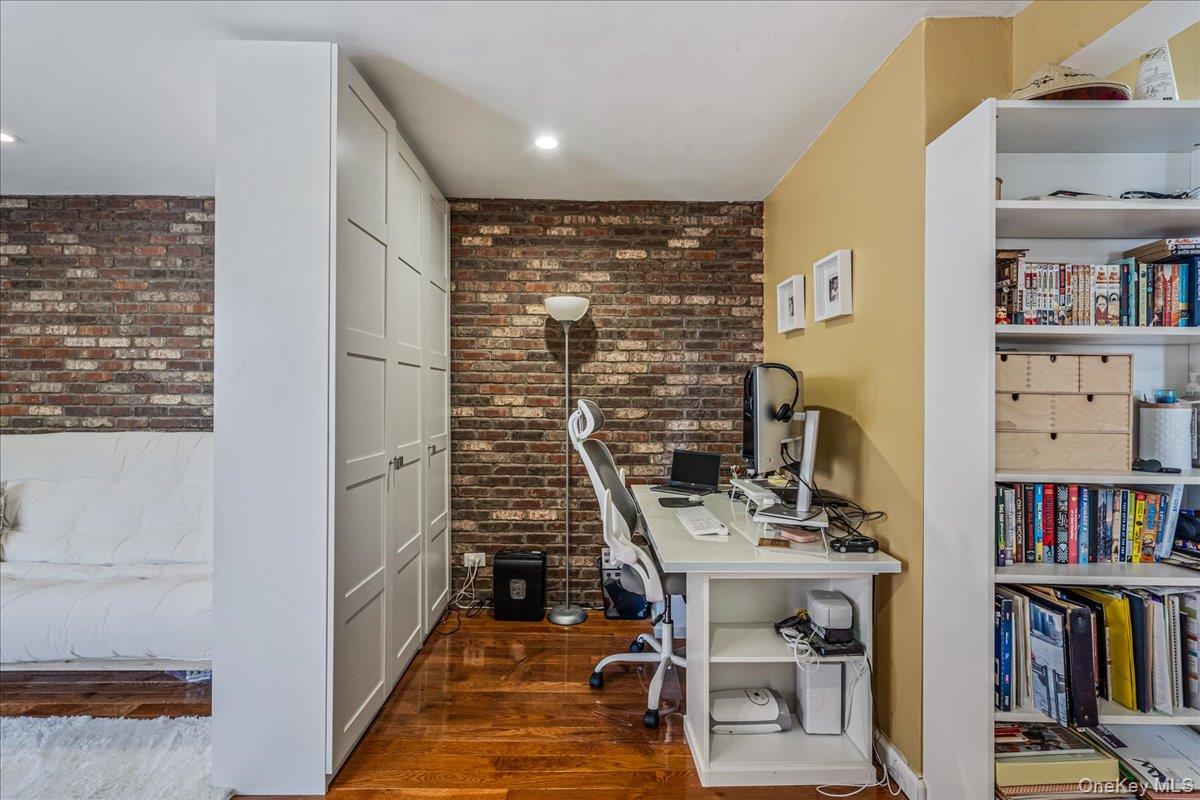144-55 Melbourne Avenue, Unit 6E Queens, NY 11367 - Photo 10 of 24 Home office featuring brick wall and dark wood finished floors