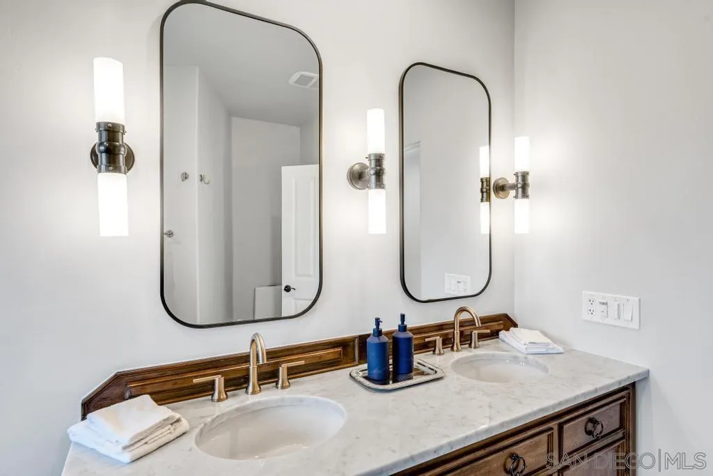 2643 Hidden Valley Road La Jolla, CA 92037 - Photo 56 of 75 a bathroom with a sink and mirror