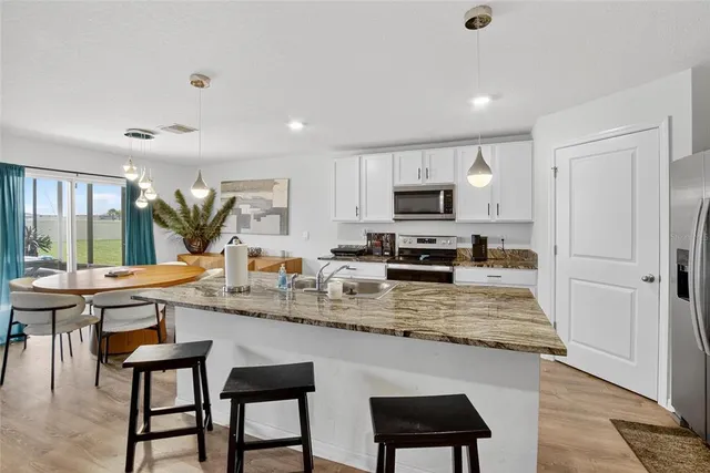 a kitchen with stainless steel appliances granite countertop a stove and a microwave