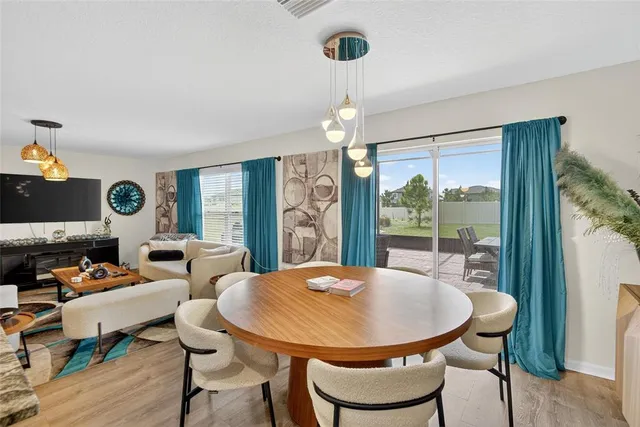 a living room with furniture fireplace and a large window