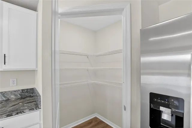 a kitchen with granite countertop a sink and a stove top oven
