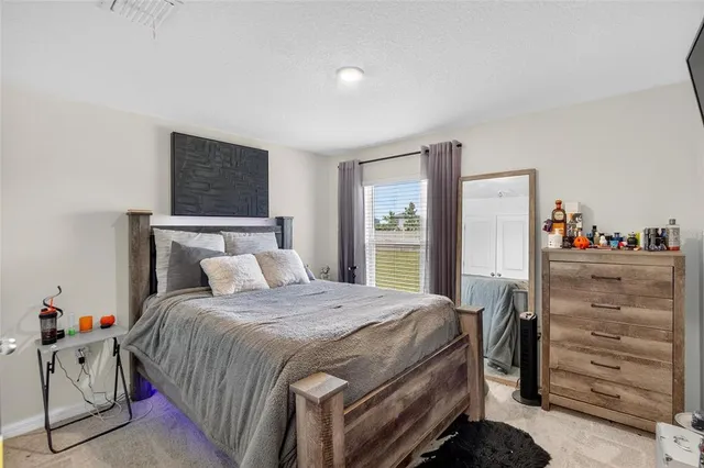 a view of a livingroom with wooden floor and a fireplace