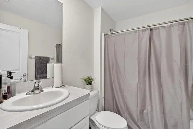 a bed room with a bed and a large mirror