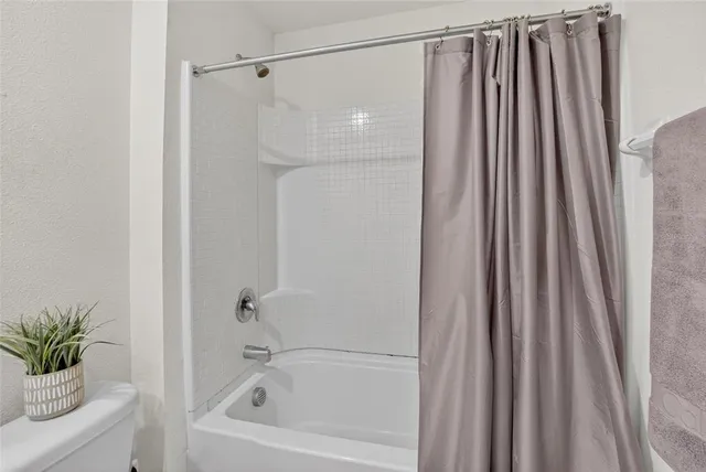 a bedroom with a bed and dresser