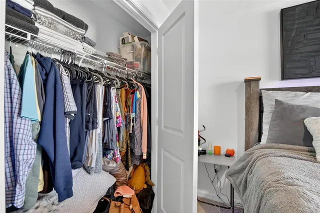 a bedroom with a large bed and a flat tv screen on dresser