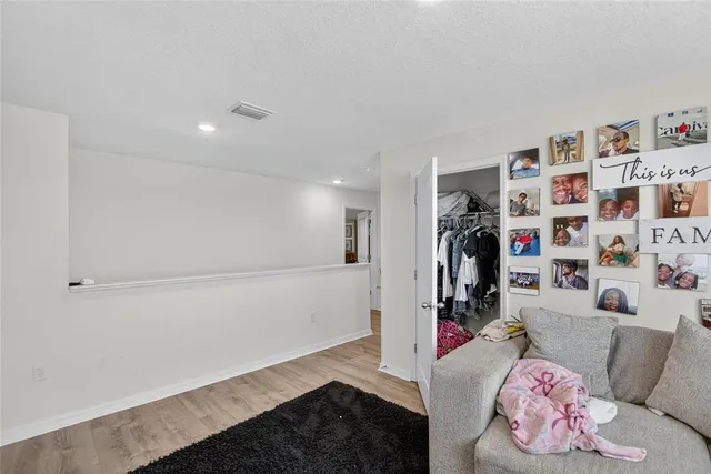 a view of a patio with chairs and floor to ceiling window
