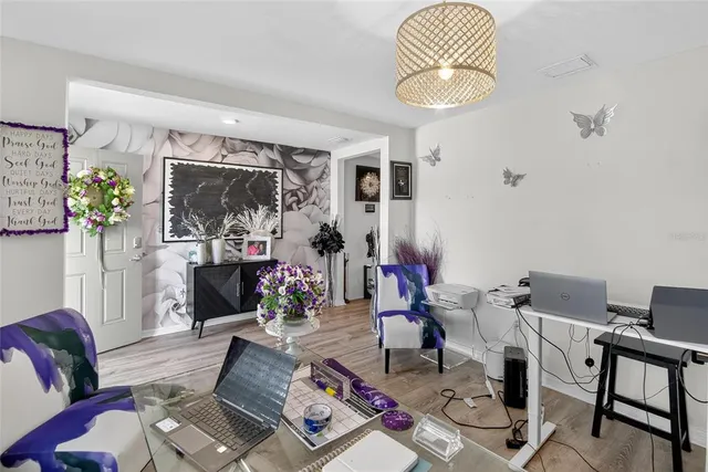 a view of a room with lots of stuff and hardwood floor