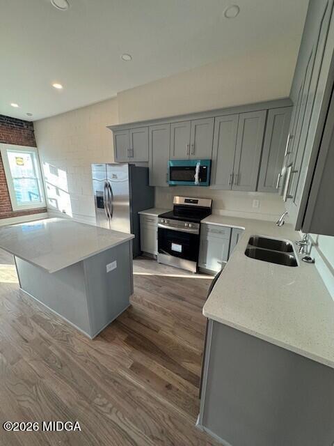 530 2nd Street, Unit B Macon, GA 31201 - Photo 5 of 13 a large kitchen with stainless steel appliances a sink a stove a microwave a counter top space and cabinets