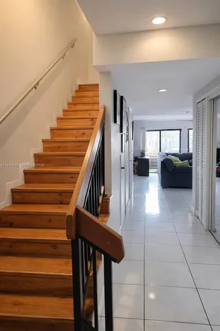 a view of entryway and hall with wooden floor