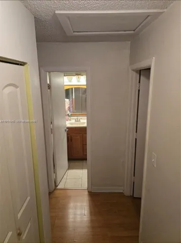 a view of a hallway to rooms