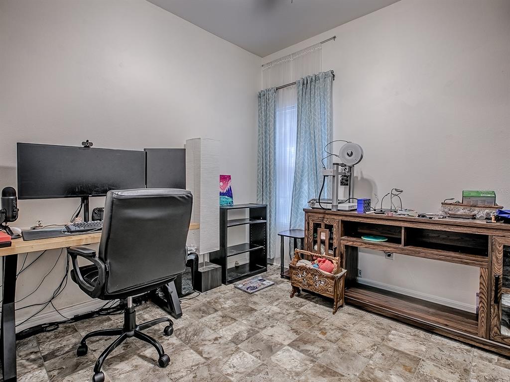 7840 Northwest 21 Way Gainesville, FL 32609 - Photo 14 of 38 a view of a workspace with furniture