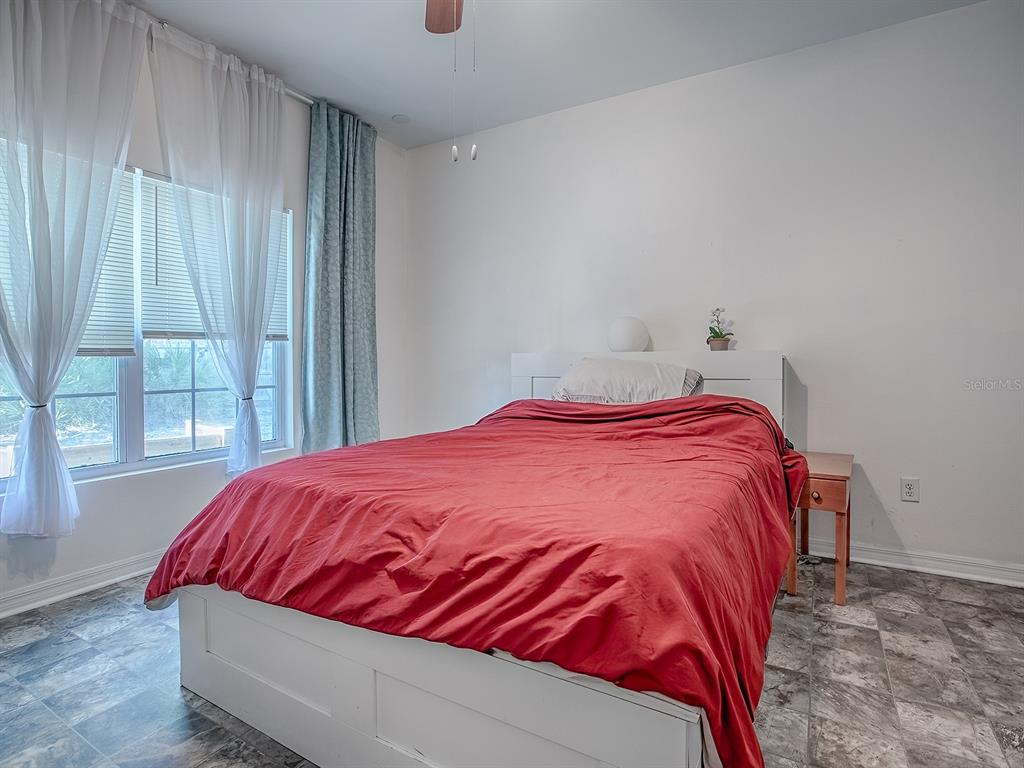 7840 Northwest 21 Way Gainesville, FL 32609 - Photo 18 of 38 a bed sitting in a bedroom next to a window