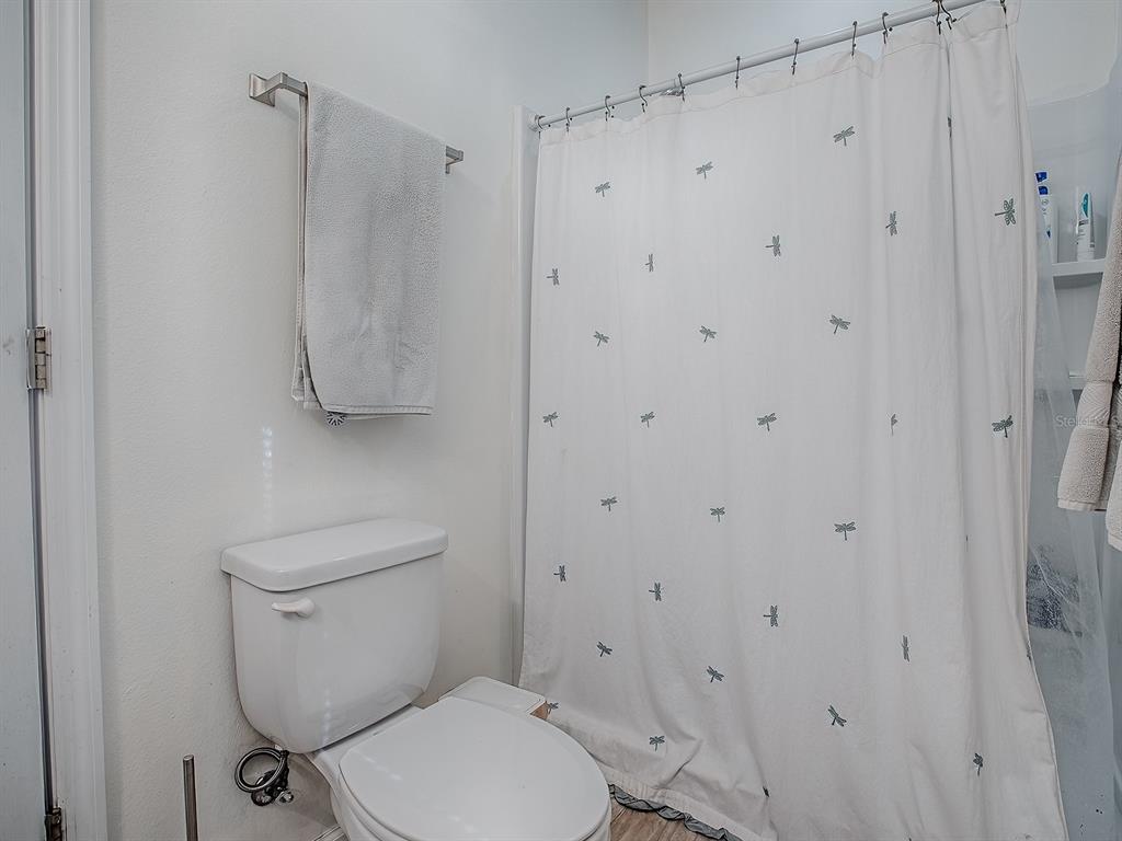 7840 Northwest 21 Way Gainesville, FL 32609 - Photo 20 of 38 a white toilet sitting next to a bathroom sink