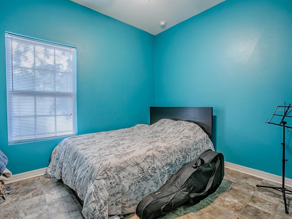 7840 Northwest 21 Way Gainesville, FL 32609 - Photo 21 of 38 a bed sitting in a bedroom next to a window