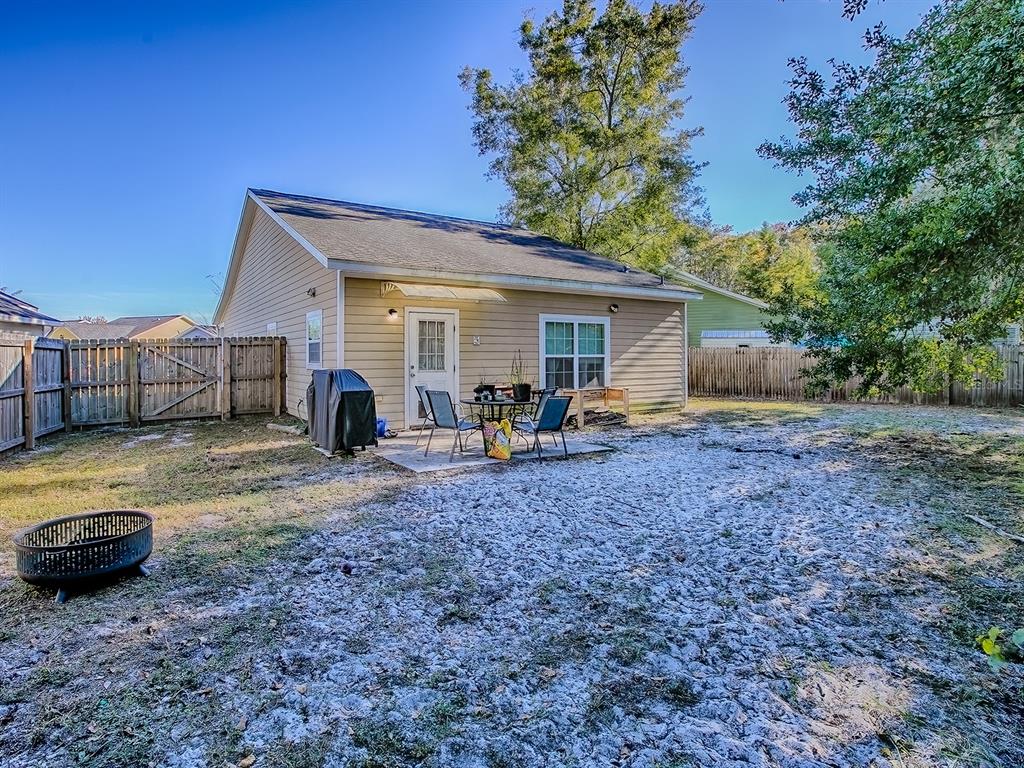 7840 Northwest 21 Way Gainesville, FL 32609 - Photo 23 of 38 a view of a backyard with furniture and a fire pit