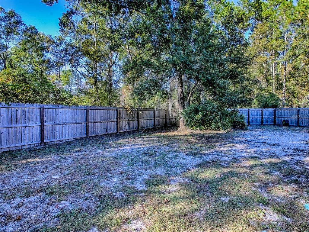 7840 Northwest 21 Way Gainesville, FL 32609 - Photo 25 of 38 a view of backyard with green space and wooden fence