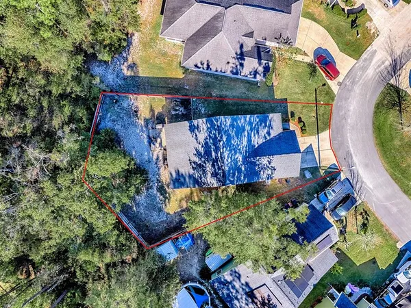 an aerial view of residential houses with outdoor space and street view