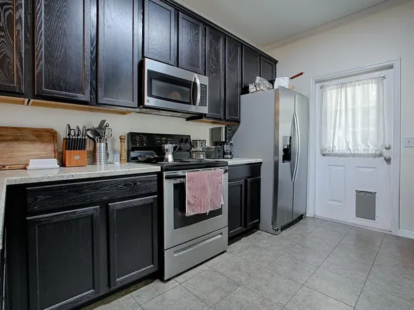 a kitchen with stainless steel appliances granite countertop a stove a sink dishwasher and a microwave