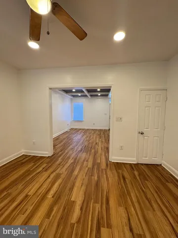 a view of a room with wooden floor