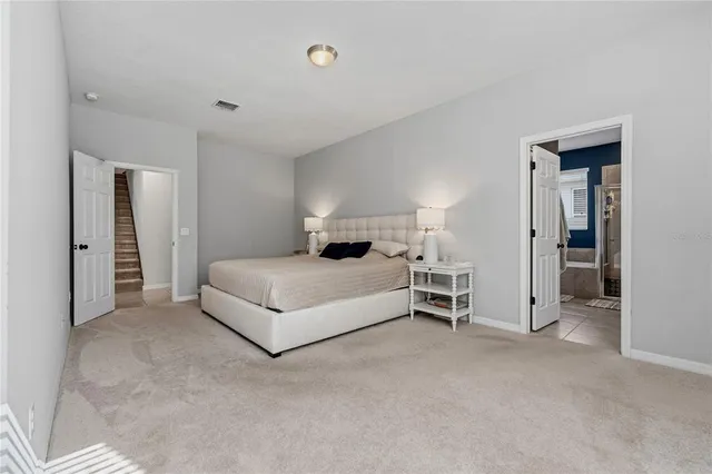 a bedroom with a bed and a white cabinet