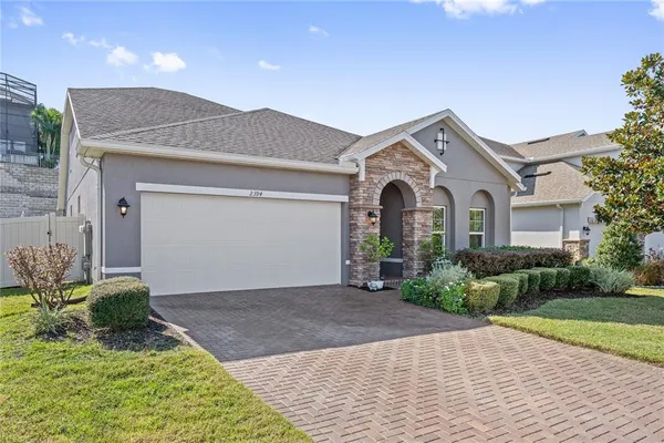 a front view of a house with a yard and garage
