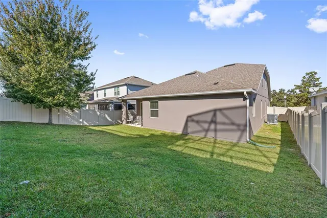 a view of a house with a backyard