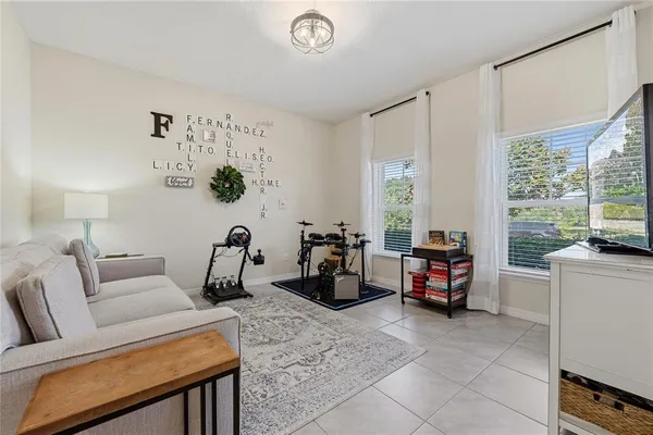a living room with furniture a window and a flat screen tv