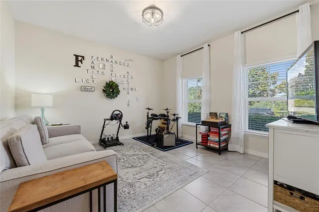 a living room with furniture a window and a flat screen tv