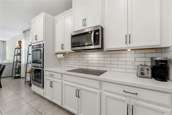 a kitchen with cabinets stainless steel appliances and a counter top space