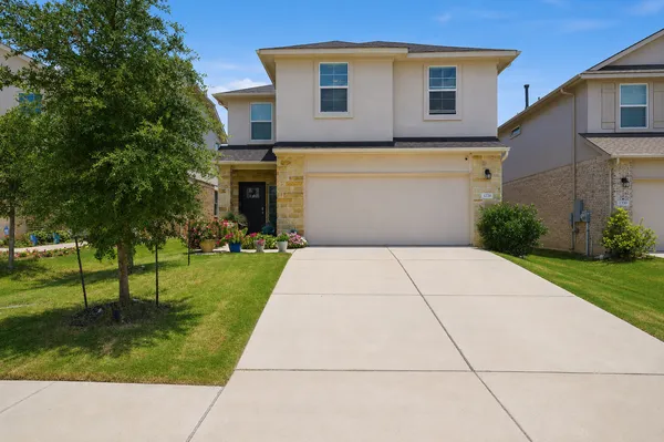 a front view of a house with a yard