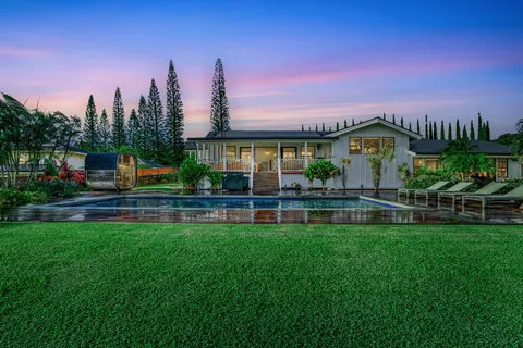 a front view of a house with swimming pool having outdoor seating