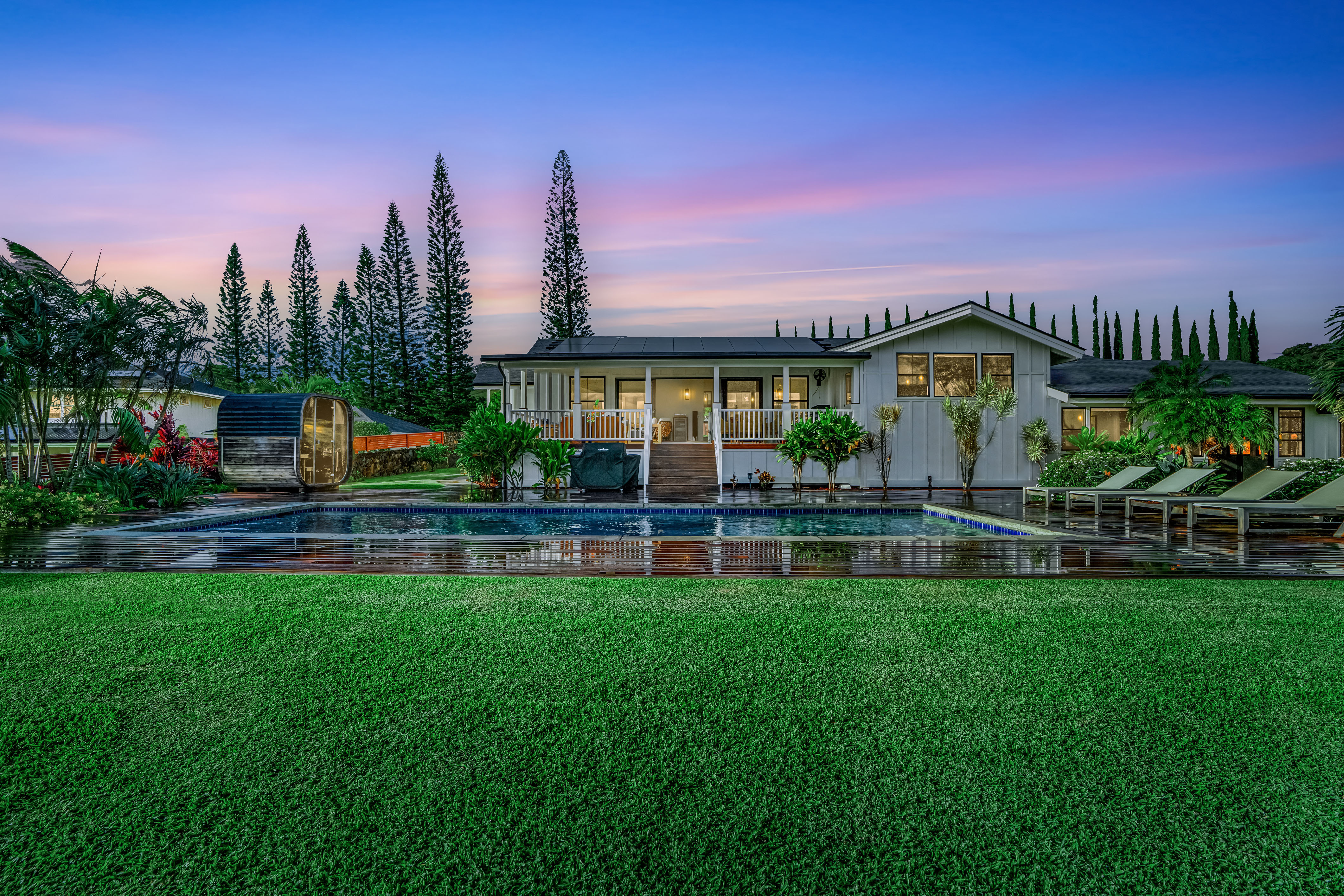 a front view of a house with swimming pool having outdoor seating