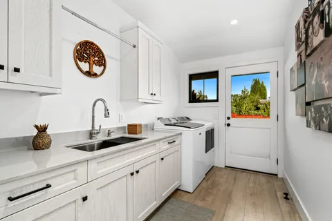 a kitchen with a sink cabinets and window