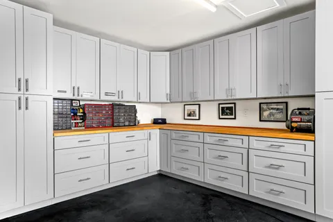 a kitchen with granite countertop white cabinets and sink
