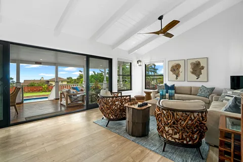 a living room with furniture and a floor to ceiling window