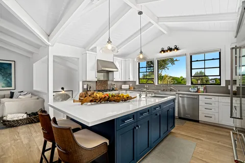a kitchen with a stove a sink dishwasher and a refrigerator
