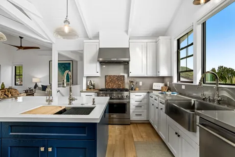 a kitchen with a sink stove and cabinets