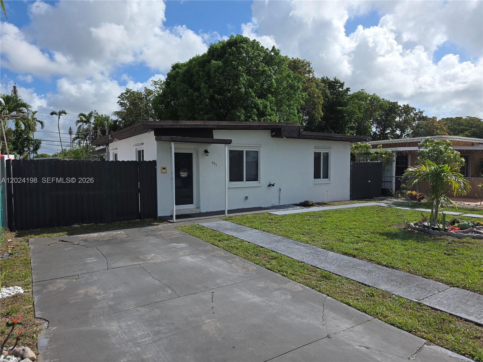 651 East 48th Street Hialeah, FL 33013 - Photo 2 of 52 a house view with a garden space