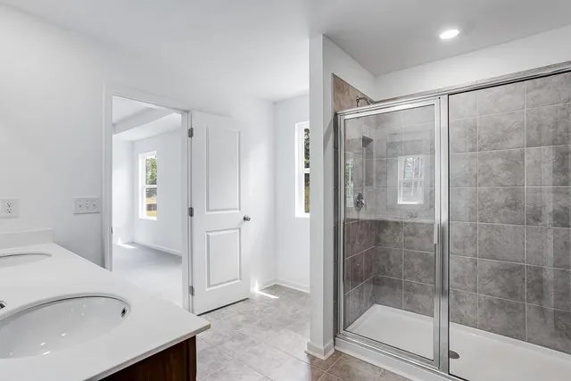 a bathroom with a shower and a sink