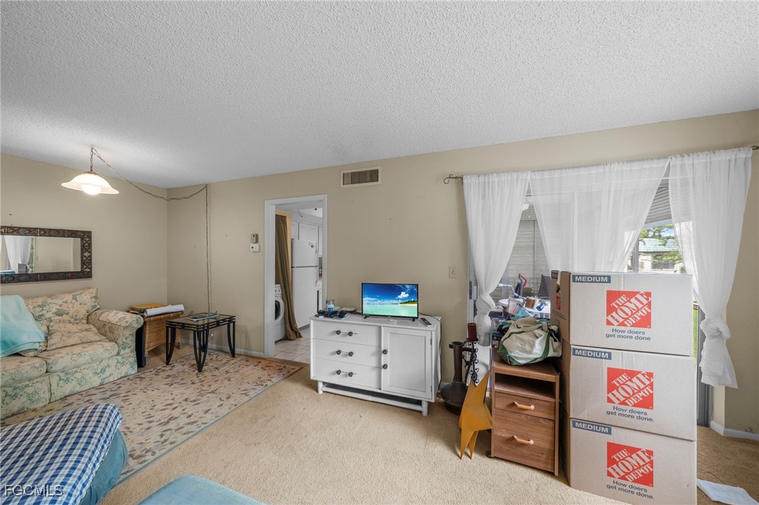 202 Bobolink Way, Unit 202B Naples, FL 34105 - Photo 11 of 31 a bedroom with furniture and a bed