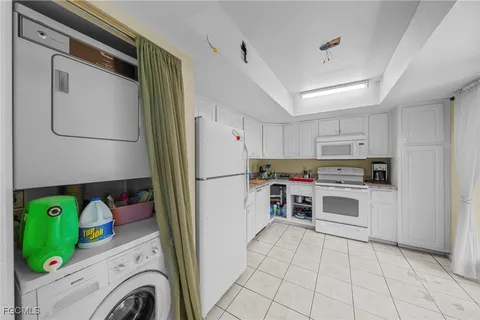 a kitchen with refrigerator and cabinets