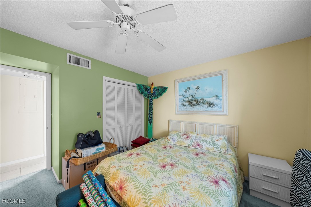 202 Bobolink Way, Unit 202B Naples, FL 34105 - Photo 18 of 31 a bedroom with a bed and wooden floor